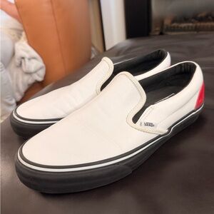 Vans White Leather Slip-On Sneakers with Black Sole and Red Heel